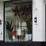 Stylish fashion boutique display with elegant mannequins and decor in a modern storefront.