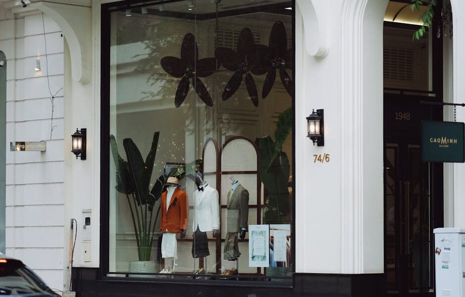 Stylish fashion boutique display with elegant mannequins and decor in a modern storefront.