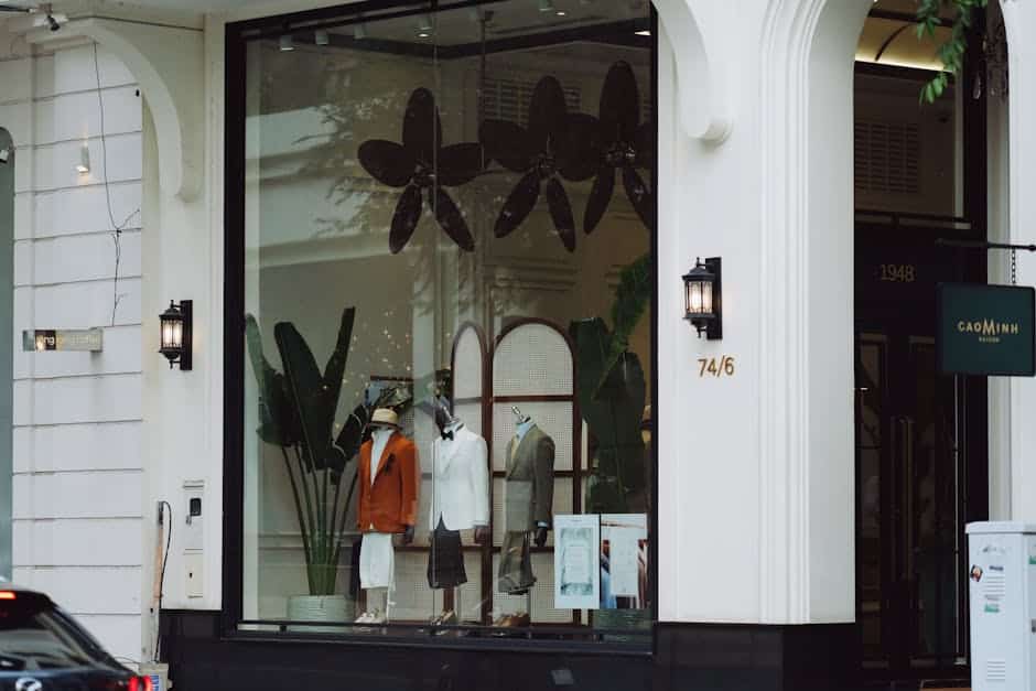 Stylish fashion boutique display with elegant mannequins and decor in a modern storefront.